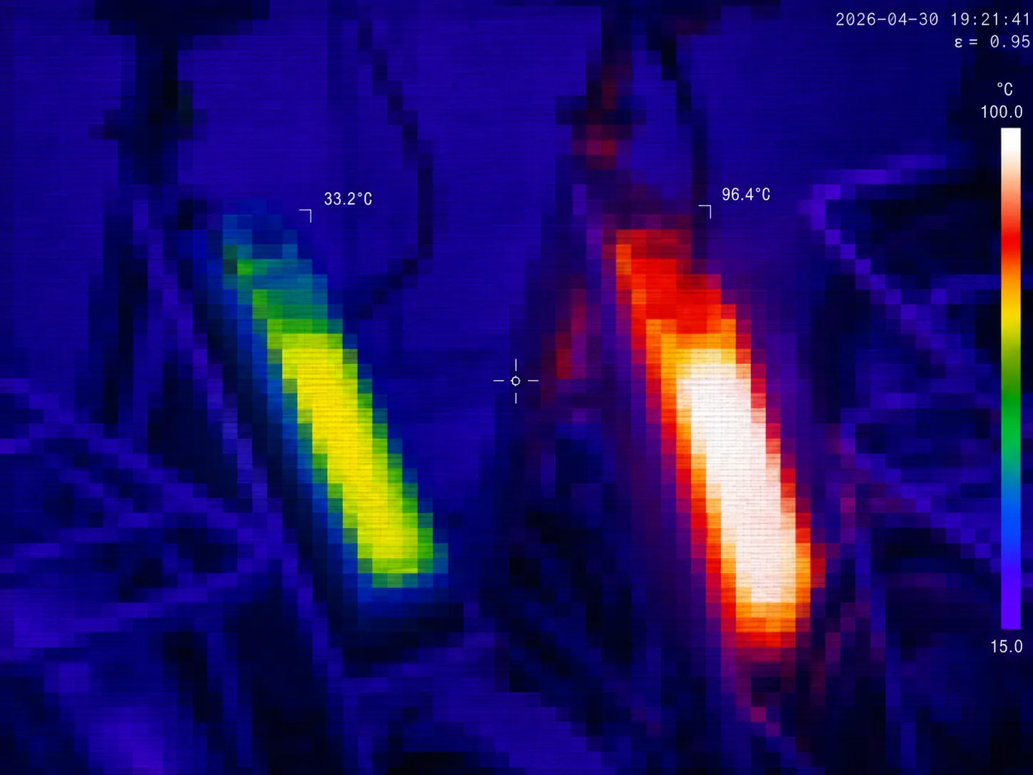 Thermal still from sensor K-0341: two e-bikes on a rack, one battery glowing hot at 96.4°C against the other near 33.2°C.